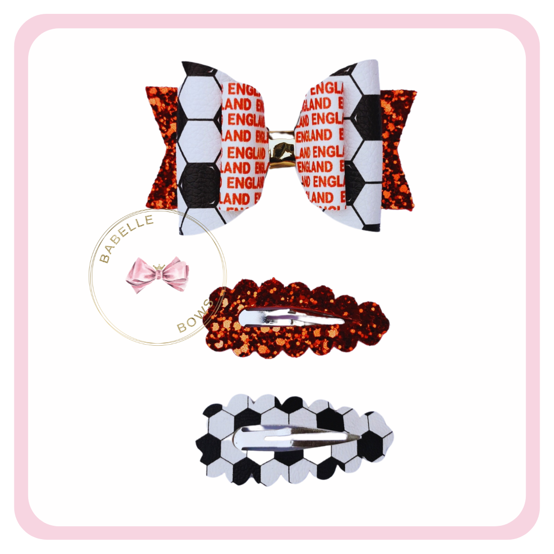 Our England football accessories will ensure you're on trend as your favourite team! Enhance your own look with a cool hair clip or add a fun accessory to your purse. Be patriotic and wear our bow or perhaps even give one to your best friend!